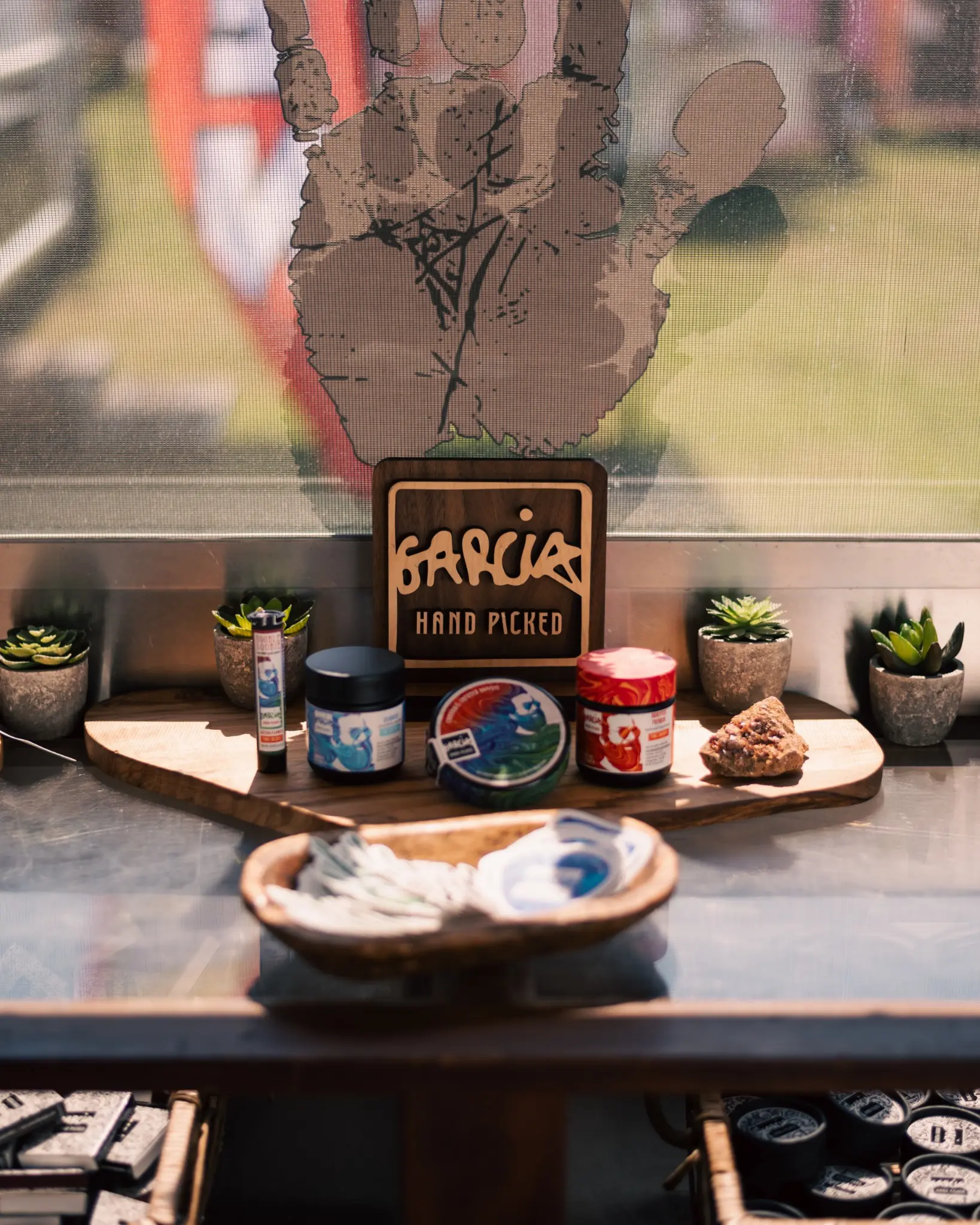 Garcia Hand Picked product family arranged with a wooden logo and plants