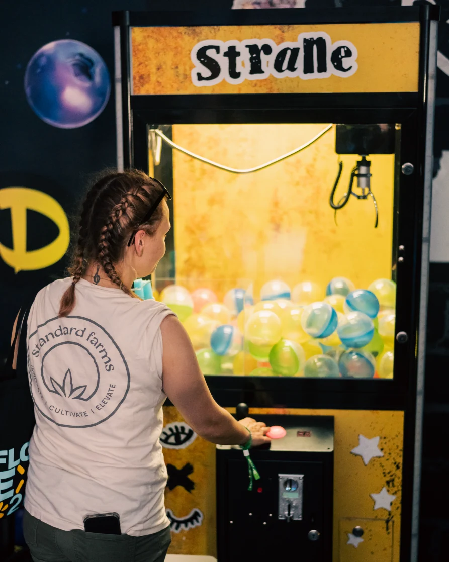 Visitor using a Strane-branded yellow claw machine